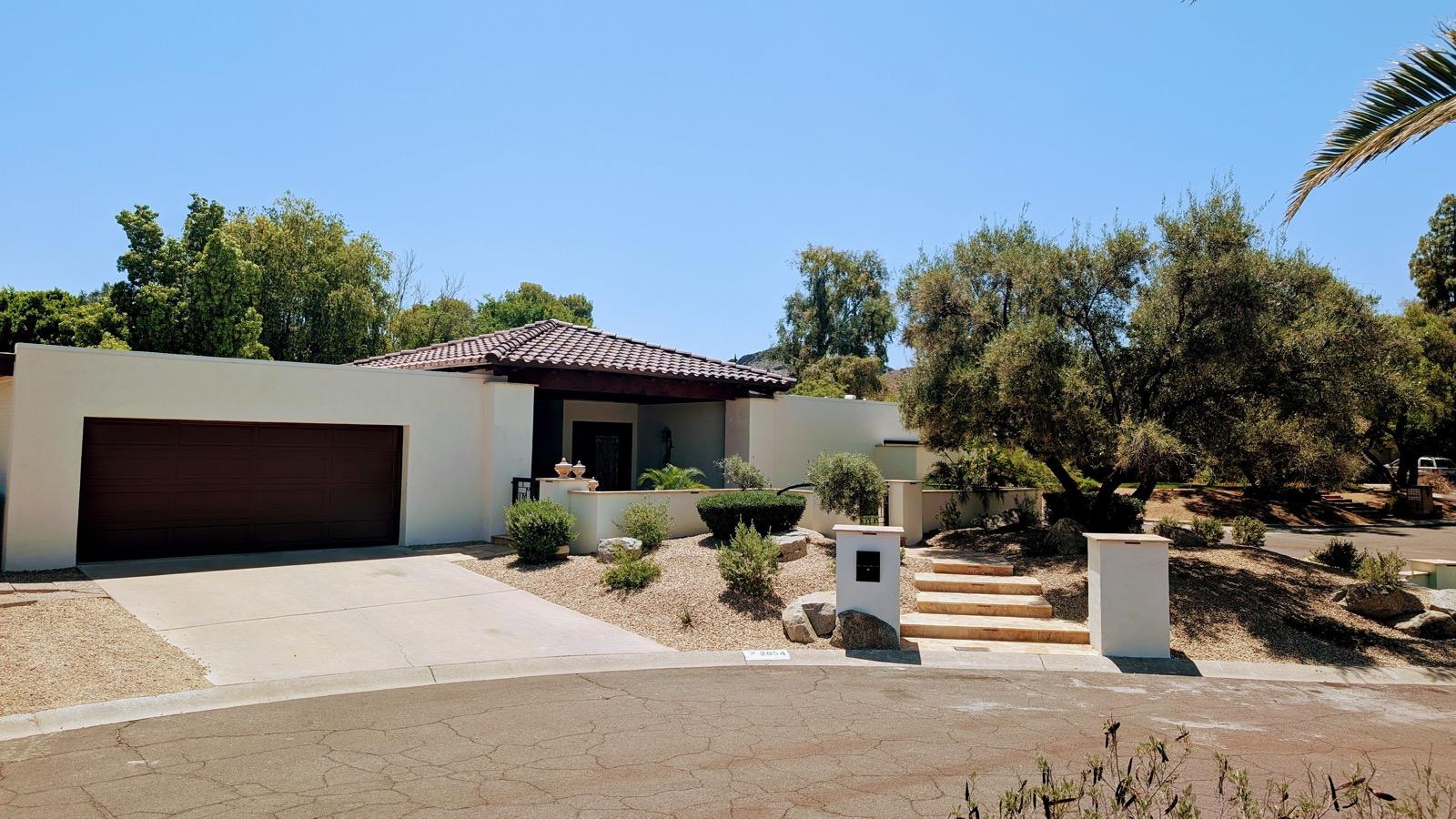 Mission project exterior after renovation — modern facade with driveway and stone entry