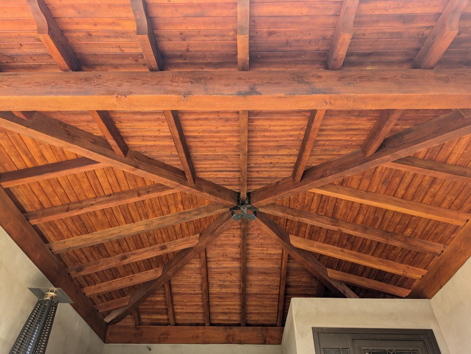 Mission project entry courtyard after — covered pavilion with radial wood beam ceiling